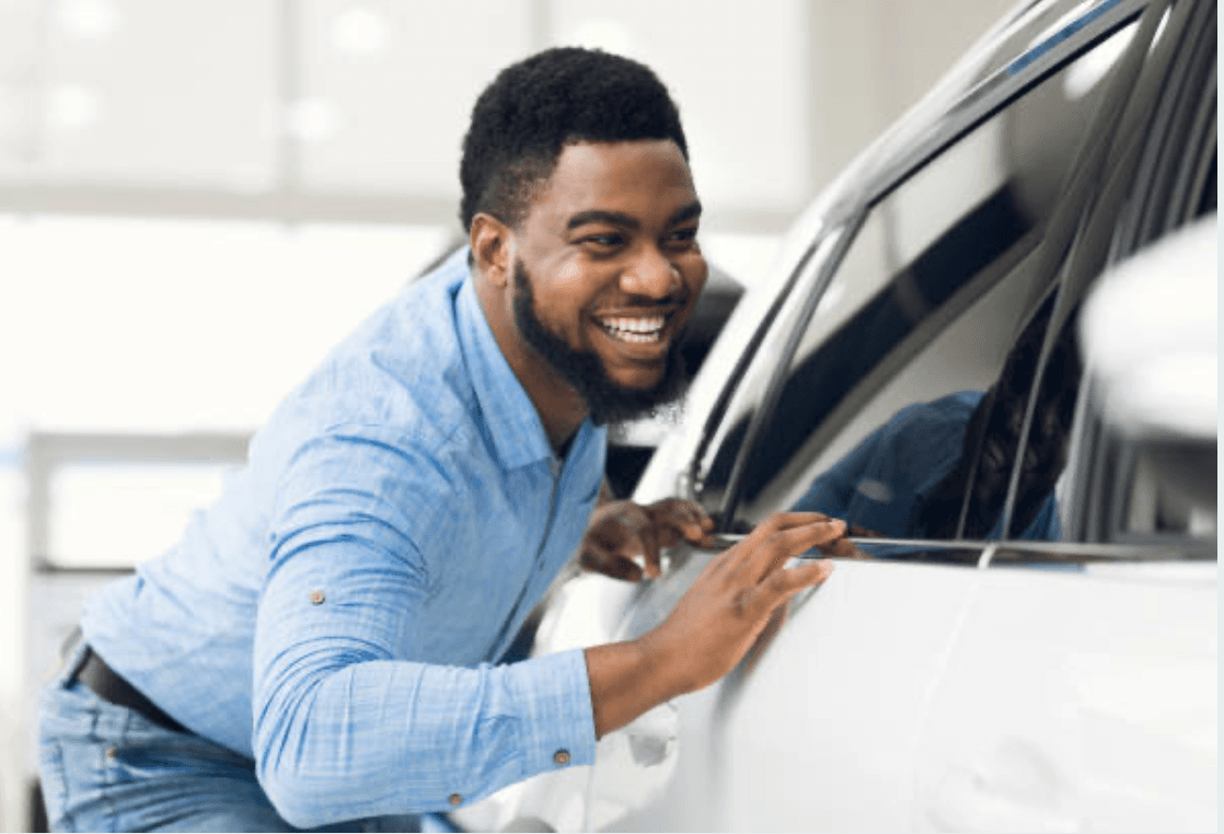 A happy Turbo Wash customer admiring their clean car