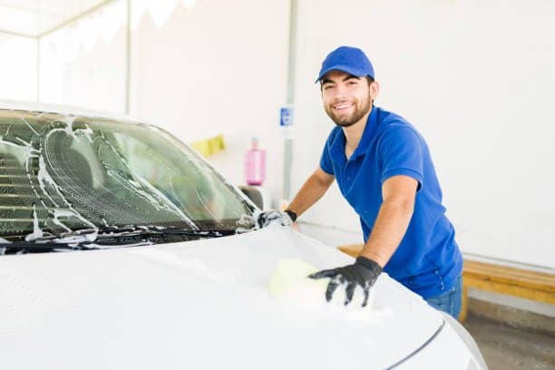 A Turbo Wash team member finishing a car by hand