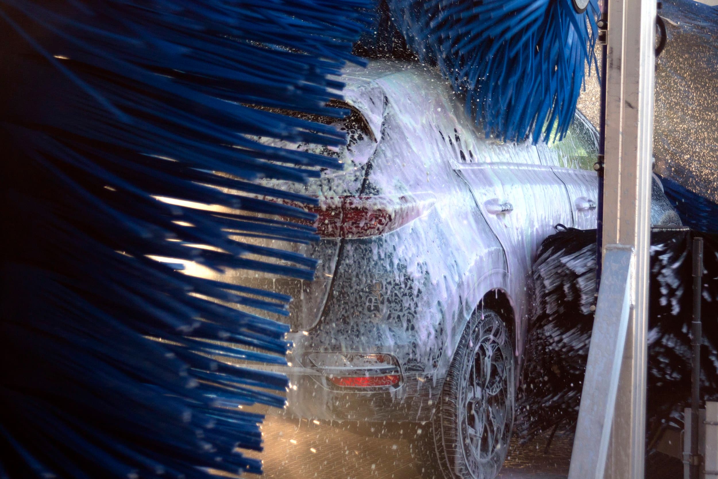 A car moving through the finishing stages of the Turbo Wash tunnel