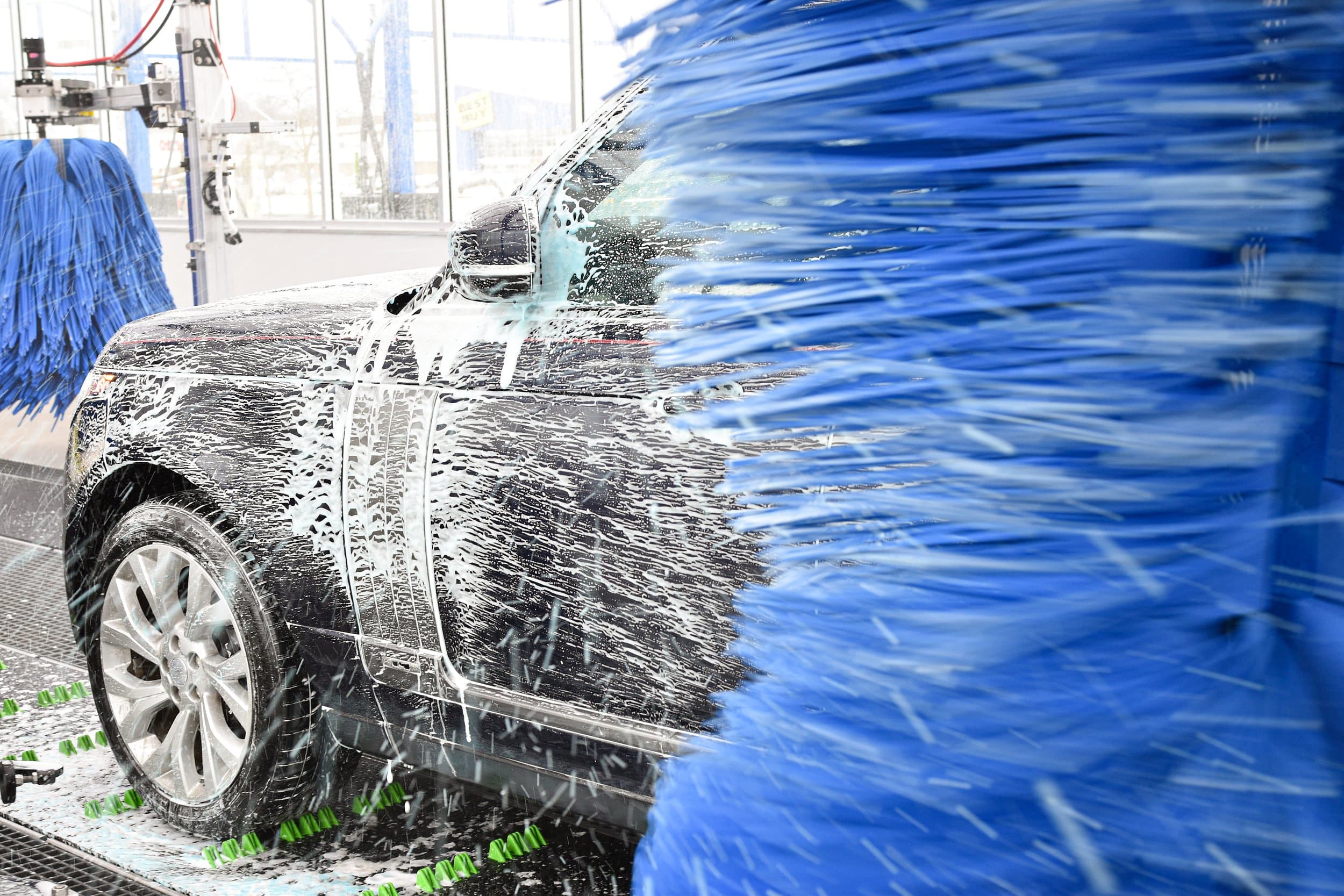 Colorful foam washing over a car at Turbo Wash